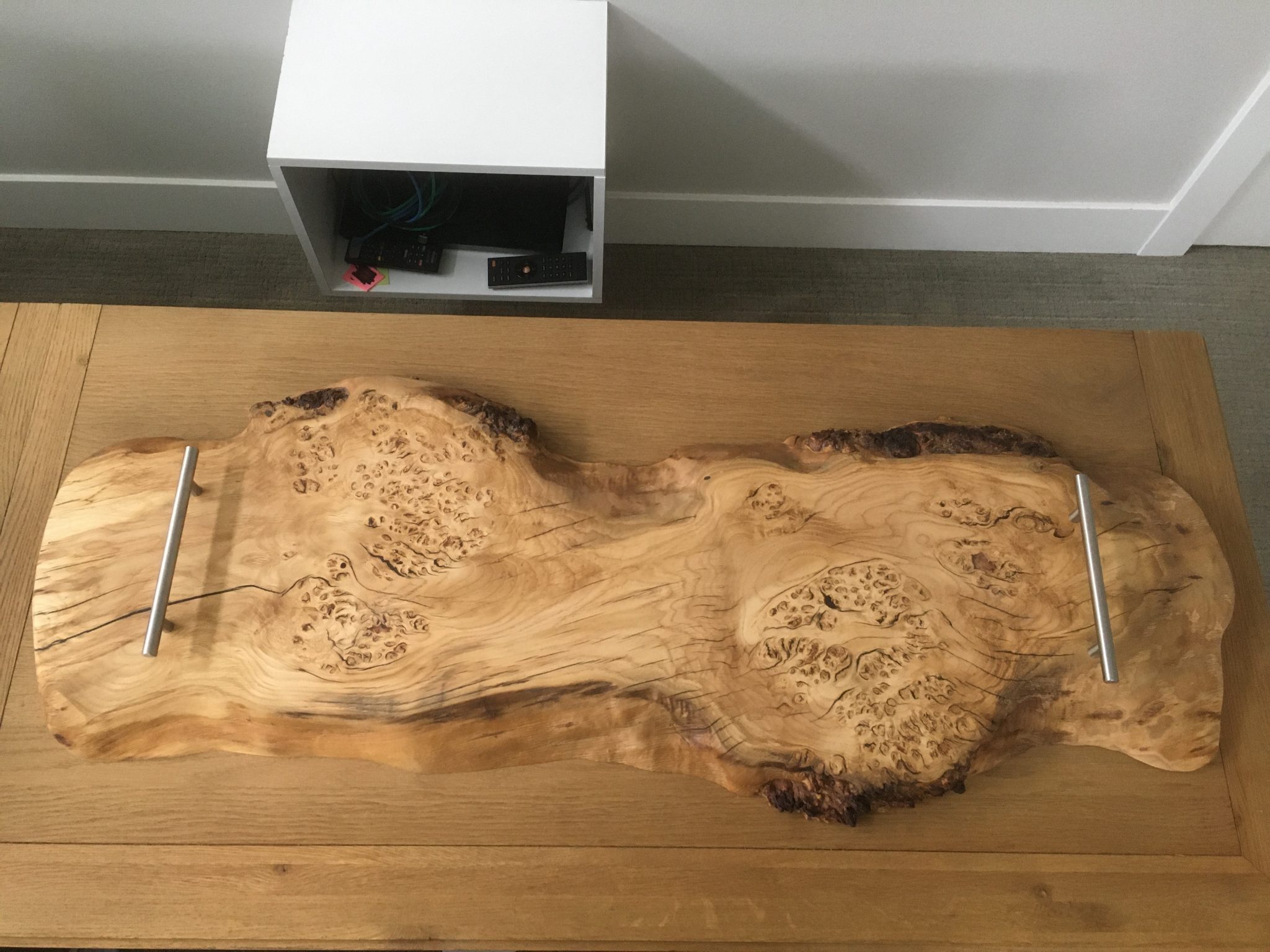 Natural wood slab with burled knots and organic grain patterns on display table