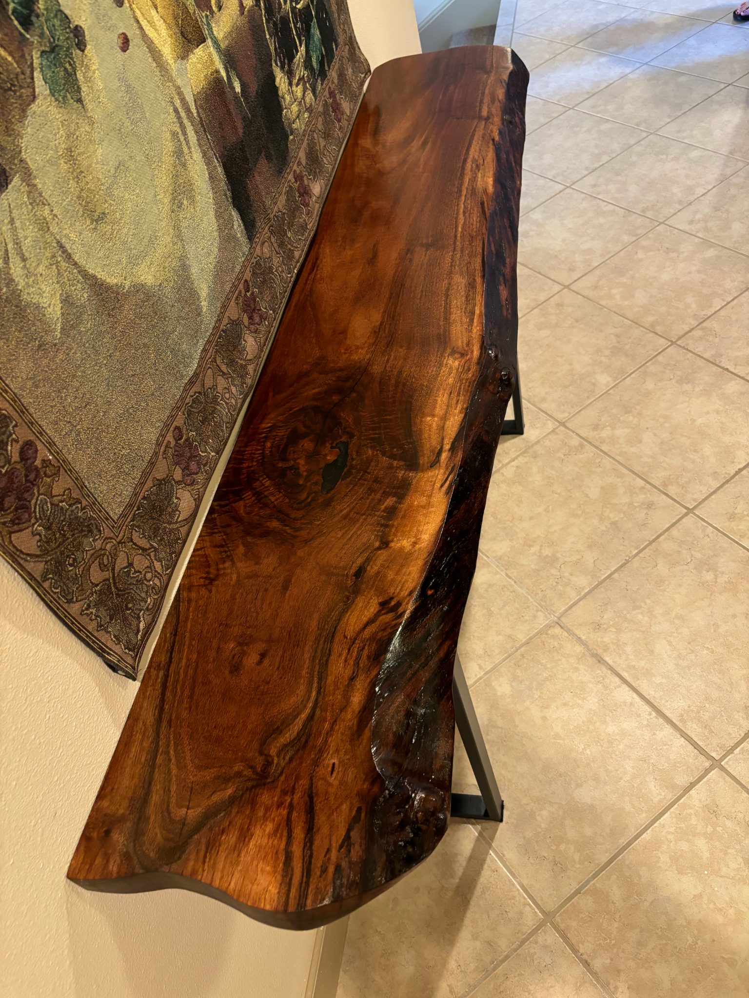 Rustic wooden bench with natural grain and finish displayed indoors on tile flooring
